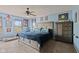 Comfortable bedroom with a ceiling fan, carpet flooring, and a plush bed with a blue comforter at 3349 Capsella Ln, Indianapolis, IN 46203