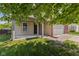 Covered front entry features sturdy support columns and a spacious front yard with healthy lawn at 3349 Capsella Ln, Indianapolis, IN 46203