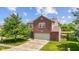 A view of a well-maintained two story home with a brick facade, driveway and front yard at 3349 Capsella Ln, Indianapolis, IN 46203