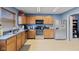 Well lit kitchen showing stainless steel appliances, ample cabinet space, and tile floors at 3349 Capsella Ln, Indianapolis, IN 46203