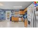 A kitchen with stainless steel appliances, wood cabinets, and blue countertops at 3349 Capsella Ln, Indianapolis, IN 46203