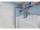 Laundry room with washer, dryer, and overhead shelving for storage at 3349 Capsella Ln, Indianapolis, IN 46203