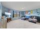 Spacious entertainment room featuring a large screen TV, comfortable seating, and natural light at 3349 Capsella Ln, Indianapolis, IN 46203