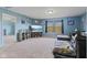 Large media room featuring comfortable seating, entertainment center and natural light at 3349 Capsella Ln, Indianapolis, IN 46203