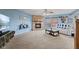 Living room featuring a brick fireplace, plush carpeting, ceiling fan, and comfortable seating at 3349 Capsella Ln, Indianapolis, IN 46203