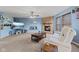 Cozy living room with brick fireplace, plush carpet, fan, and comfortable seating at 3349 Capsella Ln, Indianapolis, IN 46203