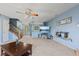 Spacious living room features plush carpeting, ceiling fan, tv and staircase to the second level at 3349 Capsella Ln, Indianapolis, IN 46203