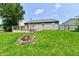 Nice backyard with a wooden deck and a fire pit perfect for outdoor gatherings at 3429 Pavetto Ln, Indianapolis, IN 46203