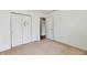 This is a bedroom featuring double closets with moon decor, neutral carpet, and an open doorway at 3429 Pavetto Ln, Indianapolis, IN 46203