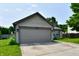 Charming single-story home featuring a two-car garage, green lawn, and mature trees at 3429 Pavetto Ln, Indianapolis, IN 46203