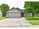 Charming single Gathering home with a well maintained lawn and concrete driveway leading to a two car garage at 3429 Pavetto Ln, Indianapolis, IN 46203