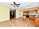 A well-lit kitchen with oak cabinets, stainless steel appliances, tile flooring, and an adjacent living area at 3429 Pavetto Ln, Indianapolis, IN 46203