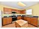 Well-lit kitchen offers stainless steel appliances, wood cabinets, and tile flooring at 3429 Pavetto Ln, Indianapolis, IN 46203