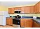 Bright kitchen featuring oak cabinets, stainless steel appliances, and blue countertops at 3429 Pavetto Ln, Indianapolis, IN 46203
