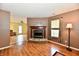 Cozy living room features a brick fireplace and wood-look flooring, creating a warm and inviting atmosphere at 3429 Pavetto Ln, Indianapolis, IN 46203