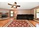 Comfortable living room with wood-look floors, a fireplace, and a ceiling fan at 3429 Pavetto Ln, Indianapolis, IN 46203
