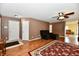 Open-concept living room with wood floors, a ceiling fan, and access to other rooms at 3429 Pavetto Ln, Indianapolis, IN 46203