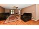 Inviting living room featuring wood-look flooring, plush furniture, and a bright entryway at 3429 Pavetto Ln, Indianapolis, IN 46203