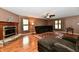 Bright living room showcases a fireplace, plush sofa, ceiling fan and wood-look floors, perfect for relaxation at 3429 Pavetto Ln, Indianapolis, IN 46203