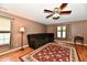 Comfortable living room boasts a ceiling fan, plush seating, and natural light from the large window at 3429 Pavetto Ln, Indianapolis, IN 46203