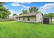 Backyard of home, with a grass lawn and storage shed at 4007 Knollwood Ave, Franklin, IN 46131
