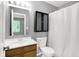 Bathroom with a wood vanity, mirror, toilet and a combination shower and tub at 4007 Knollwood Ave, Franklin, IN 46131
