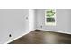 A simple bedroom features hardwood floors, neutral walls and a window looking out to the yard at 4007 Knollwood Ave, Franklin, IN 46131