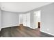 A bright bedroom features hardwood floors, neutral walls, and view of the bathroom and closet at 4007 Knollwood Ave, Franklin, IN 46131