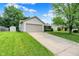 Exterior shot of a single-Gathering home showing the garage, driveway, and landscaped front lawn at 4007 Knollwood Ave, Franklin, IN 46131