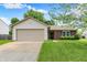 Charming single-story home featuring a brick facade, attached two-car garage, and well-maintained lawn at 4007 Knollwood Ave, Franklin, IN 46131