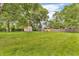 Backyard with mature trees and a wooden shed at 407 Woodland E Dr, Greenfield, IN 46140