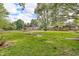View of home from backyard featuring a shed and firepit at 407 Woodland E Dr, Greenfield, IN 46140