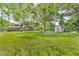 Expansive backyard with mature trees, a shed, and plenty of green space at 407 Woodland E Dr, Greenfield, IN 46140