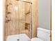 Modern shower with glass door, rainfall shower head, and integrated shelving, enhances your bathing experience at 407 Woodland E Dr, Greenfield, IN 46140