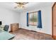 Inviting bedroom with a ceiling fan and natural light, complete with an area ideal for a compact home office at 407 Woodland E Dr, Greenfield, IN 46140