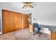 Bright bedroom featuring a built-in desk and ample closet space, perfect for study and storage at 407 Woodland E Dr, Greenfield, IN 46140