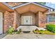 Close-up of the front entrance highlighting the double doors and brickwork of the exterior at 407 Woodland E Dr, Greenfield, IN 46140