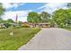 Charming single-story brick home with a long gravel driveway and well-maintained lawn at 407 Woodland E Dr, Greenfield, IN 46140