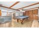 Stylish game room with a ping pong table, wood beamed ceilings, and a convenient kitchenette at 407 Woodland E Dr, Greenfield, IN 46140