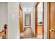 Inviting hallway featuring neutral walls, wood trim and doors, and access to the upper level at 407 Woodland E Dr, Greenfield, IN 46140