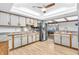 Bright eat-in kitchen with stainless steel appliances and wood grain vinyl flooring at 407 Woodland E Dr, Greenfield, IN 46140