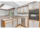 Clean kitchen featuring stainless steel appliances, a stainless steel sink and plenty of cabinet space at 407 Woodland E Dr, Greenfield, IN 46140