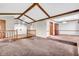 Expansive living room with high, beamed ceilings, plush carpet, and an open layout at 407 Woodland E Dr, Greenfield, IN 46140