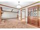 Cozy living room featuring a fireplace and a large antique cabinet with glass doors at 407 Woodland E Dr, Greenfield, IN 46140