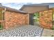 Covered patio with brick siding and a geometric patterned outdoor rug at 407 Woodland E Dr, Greenfield, IN 46140
