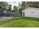 Spacious backyard offers a lush lawn, detached garage, and a patio area, ideal for outdoor activities at 4137 Rookwood Ave, Indianapolis, IN 46208