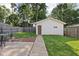 Charming backyard featuring a well-maintained lawn, patio area and detached garage, perfect for outdoor enjoyment at 4137 Rookwood Ave, Indianapolis, IN 46208