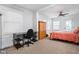 Cozy bedroom with natural light, carpeted floor, desk, ceiling fan, and a comfortable bed at 4137 Rookwood Ave, Indianapolis, IN 46208