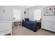 Well-lit bedroom with single bed, a dresser, large windows, neutral carpet, and light blue walls at 4137 Rookwood Ave, Indianapolis, IN 46208