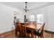 Bright dining room with wooden table, chairs, hardwood floor, and stylish lighting fixture at 4137 Rookwood Ave, Indianapolis, IN 46208